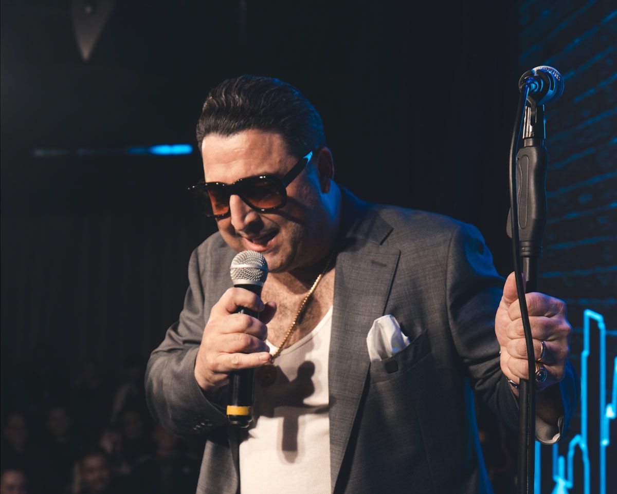 Lil Mo Mozzarella on stage doing stand up comedy